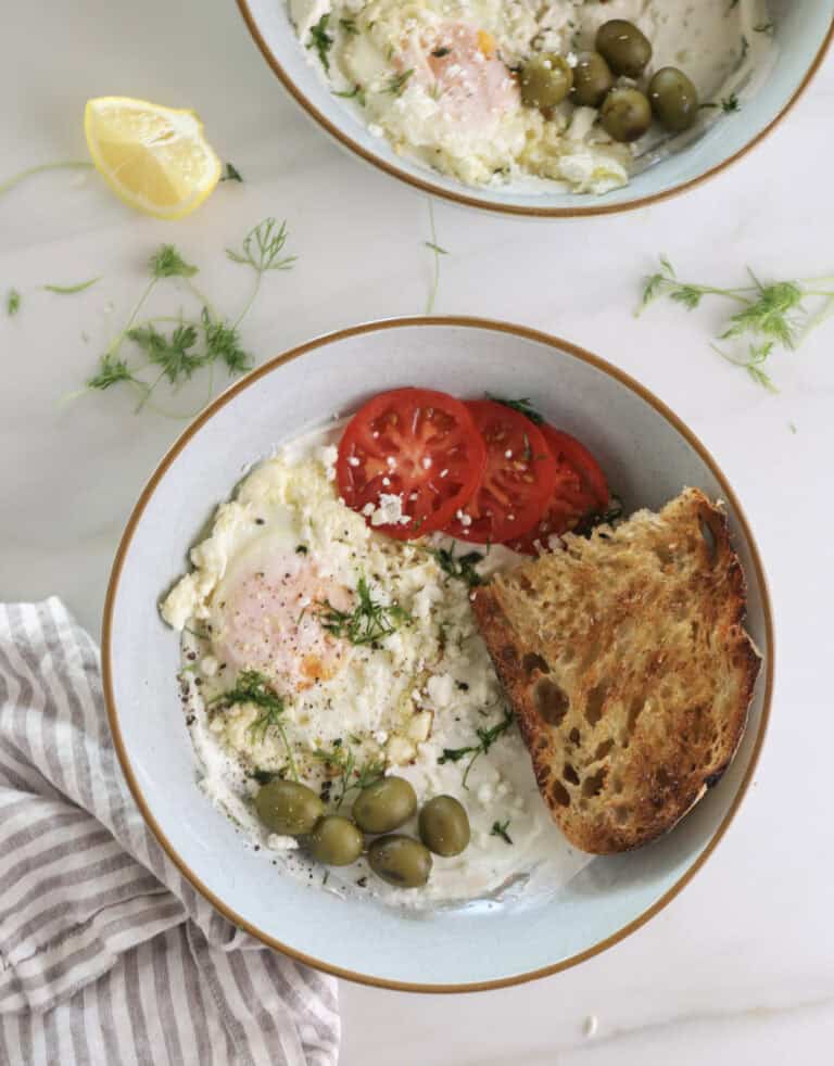 Savory Greek Yogurt Breakfast Bowls with Feta fried eggs, tomatoes, and olives.