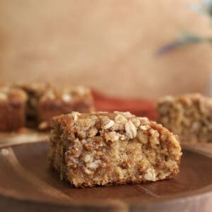 A slice of spiced oatmeal coffee cake on a plate.