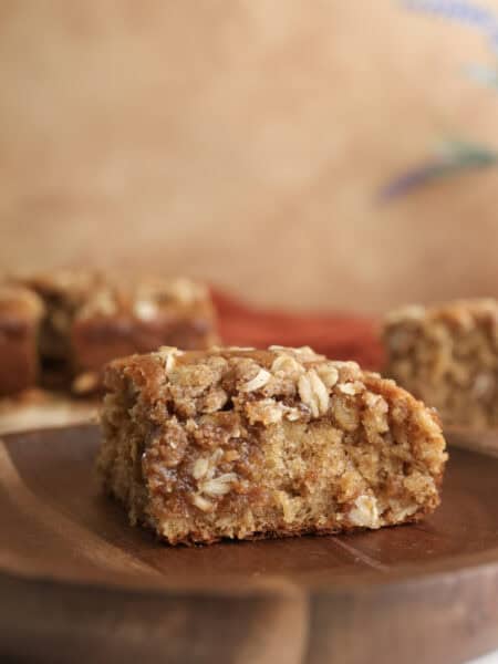 A slice of spiced oatmeal coffee cake on a plate.