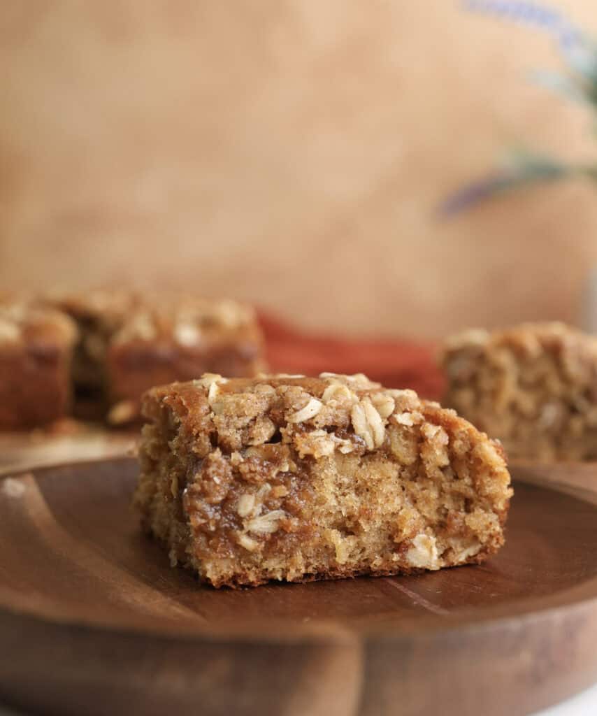 A slice of spiced oatmeal coffee cake on a plate.