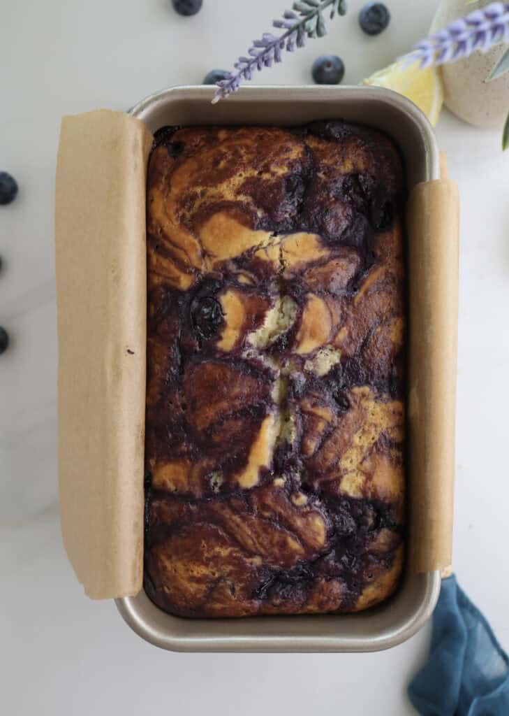 Lemon blueberry compote swirl bread in pan right out of the oven.