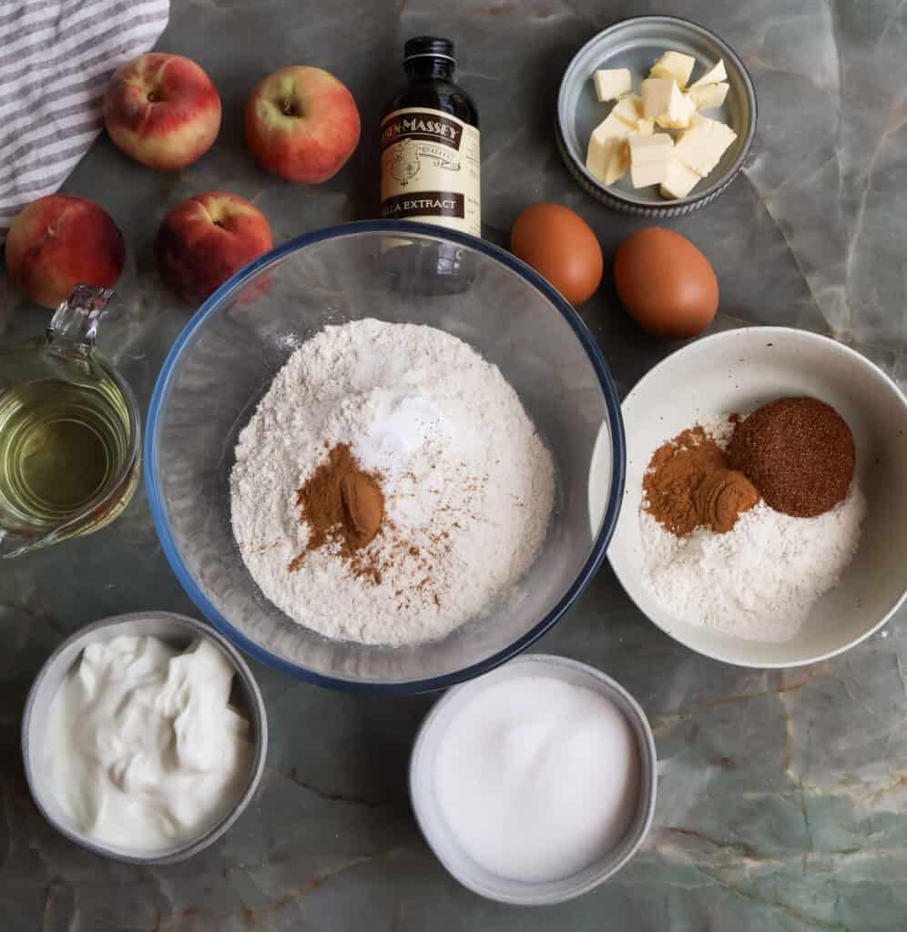 Ingredients needed to make peach cobbler bread with cinnamon crumble.