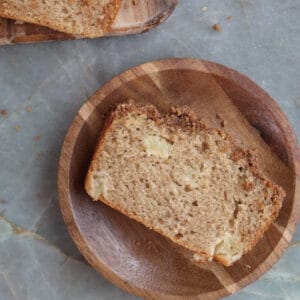 Slice of peach cobbler bread on a plate.