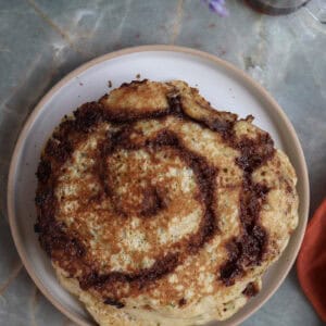 Cinnamon roll zucchini and buttermilk pancake on a plate.