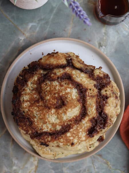 Cinnamon roll zucchini and buttermilk pancake on a plate.