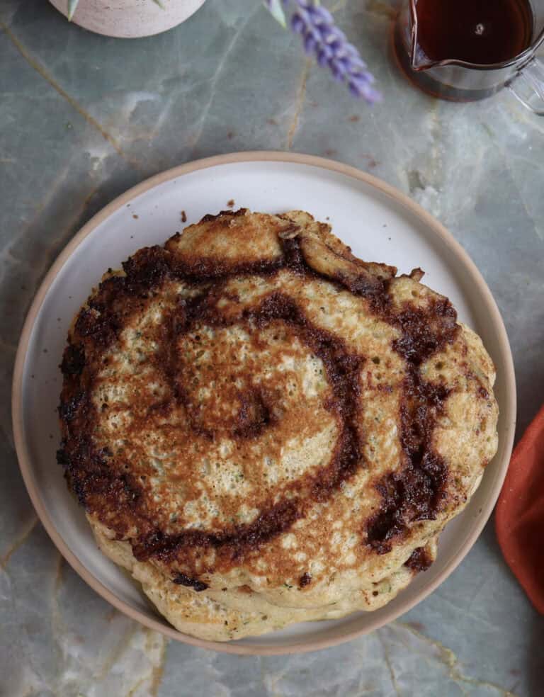 Cinnamon roll zucchini and buttermilk pancake on a plate.
