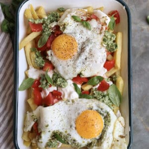 Caprese Breakfast French Fries with Pesto Fried Egg on a serving plate.