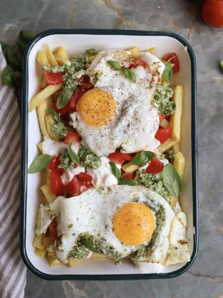 Caprese Breakfast French Fries with Pesto Fried Egg on a serving plate.