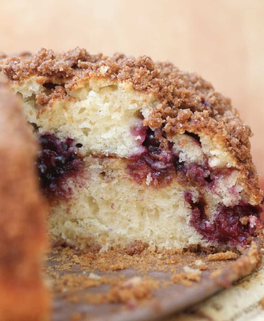 Blackberry coffee cake with a slice missing.