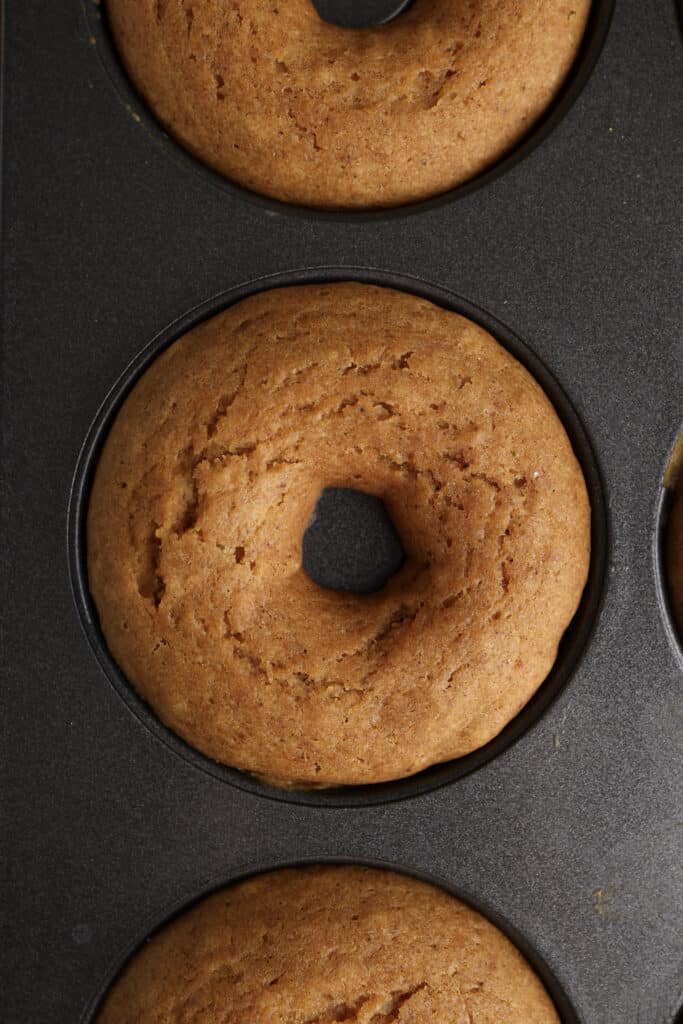 Up close of Pumpkin Donut in donut tin.