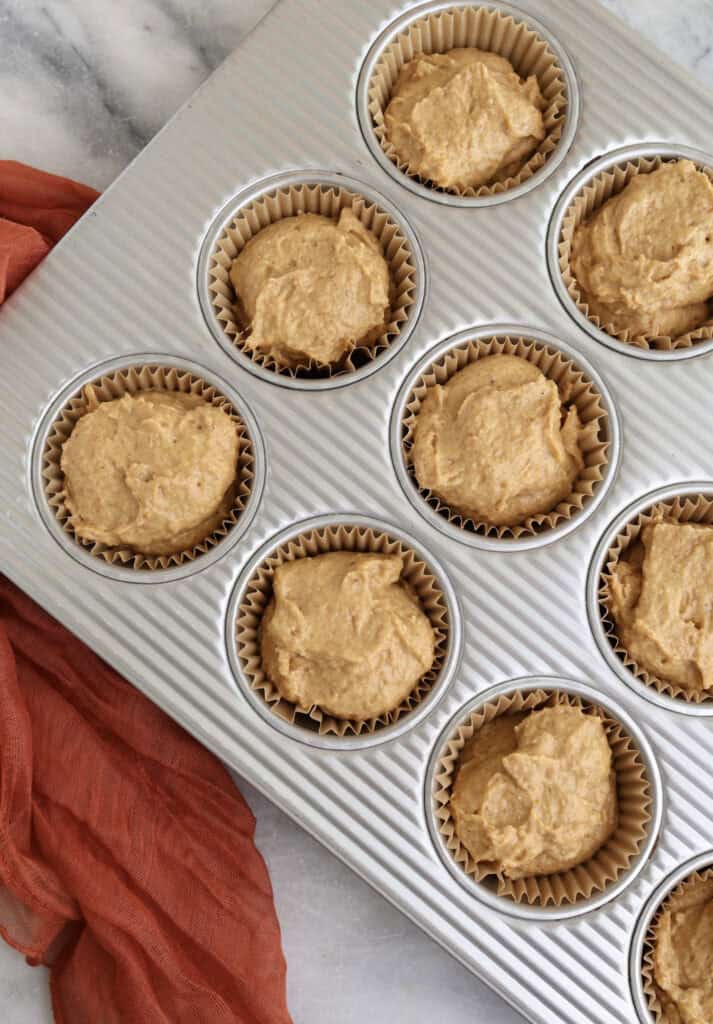 Cottage cheese pumpkin muffin batter in muffin tins before being baked.