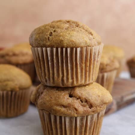 Two cottage cheese pumpkin muffins stacked on each other.