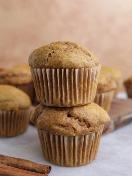 Two cottage cheese pumpkin muffins stacked on each other.