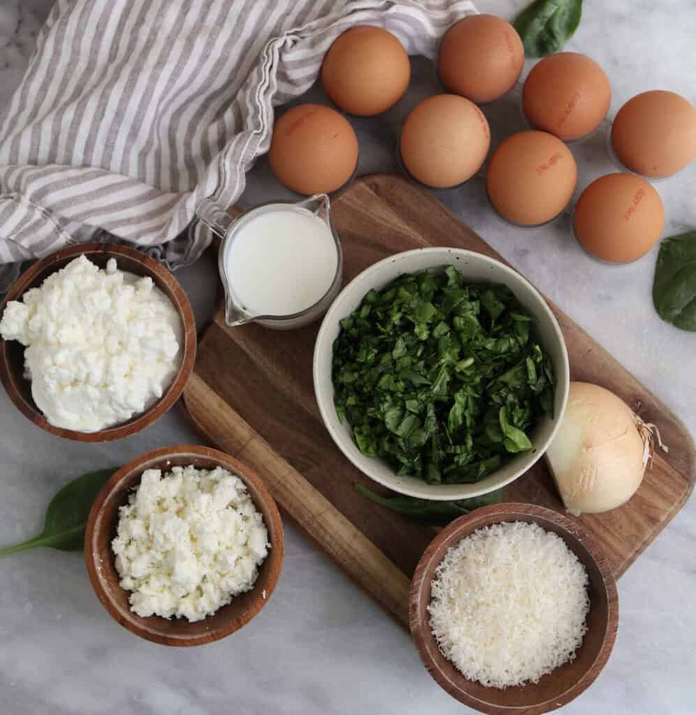 All the ingredients for the cottage cheese egg bites with feta and spinach on the counter.