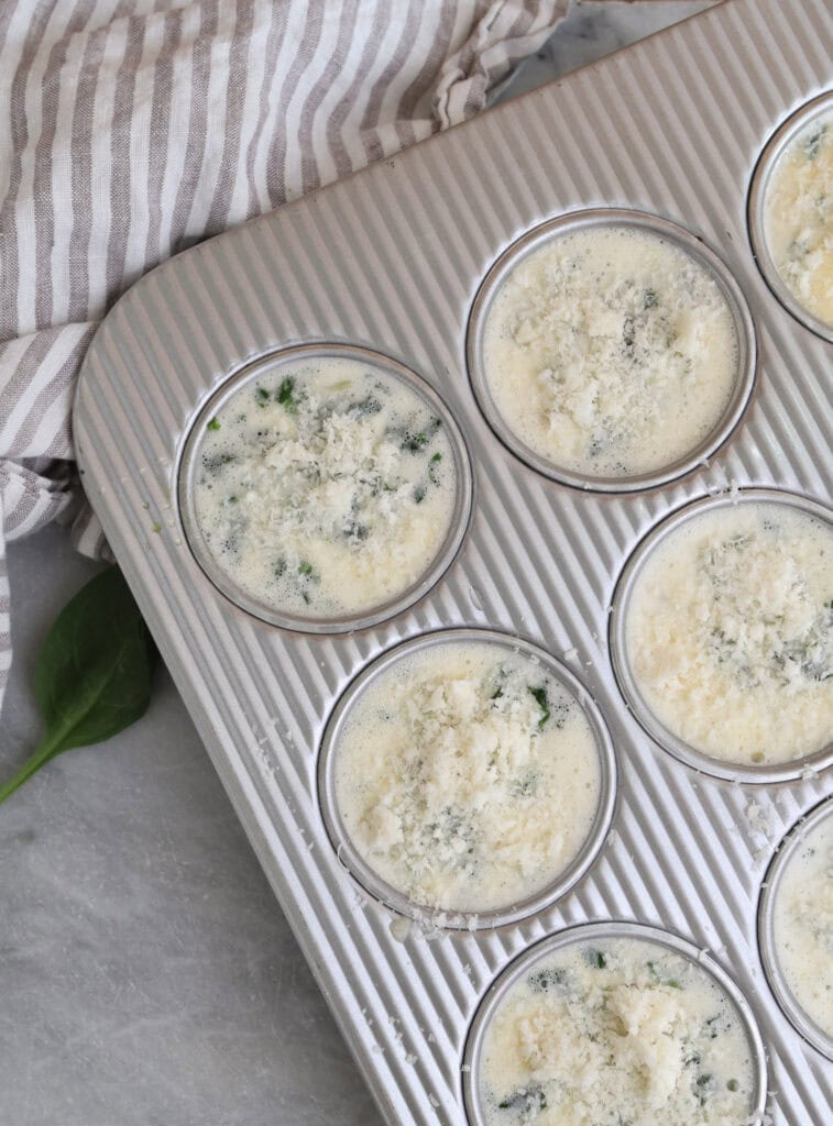 Cottage cheese egg bites in muffin tin before being baked in the oven.