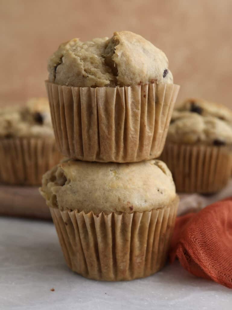 Banana Chocolate Chip Muffins stacked on each other. 