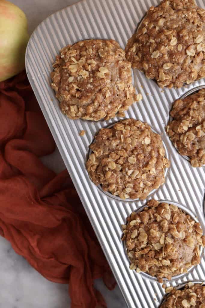 Apple oat muffins in a muffin tin right out of the oven.