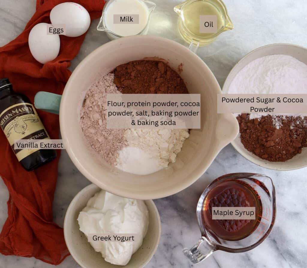 The ingredients needed to make chocolate baked donuts with chocolate glaze and protein.