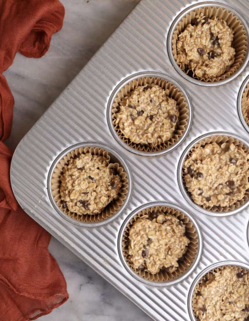 Baked oatmeal mixture in muffin tin ready to go into the oven.