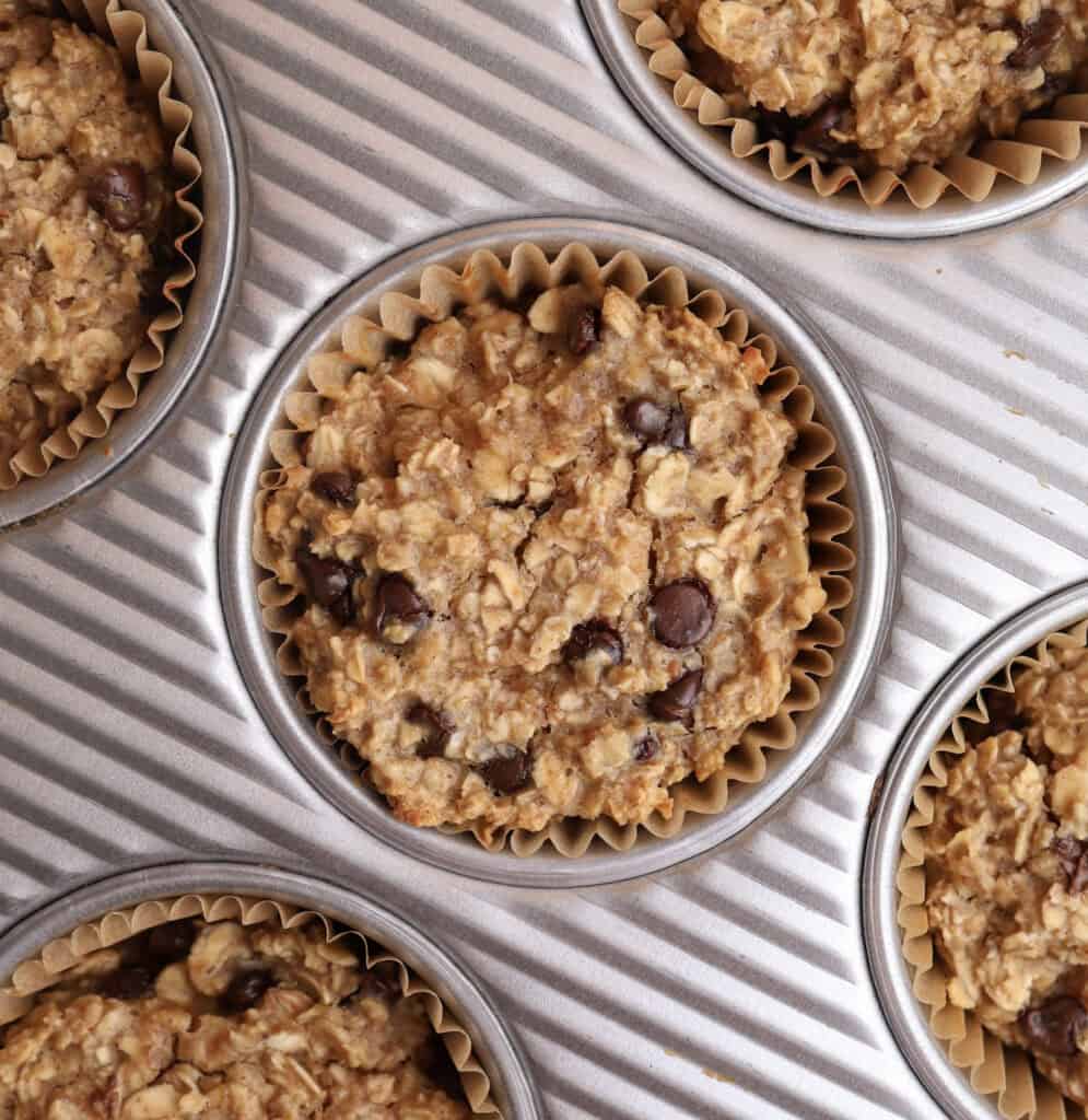 Baked oatmeal cup up close in muffin tin right out of the oven.