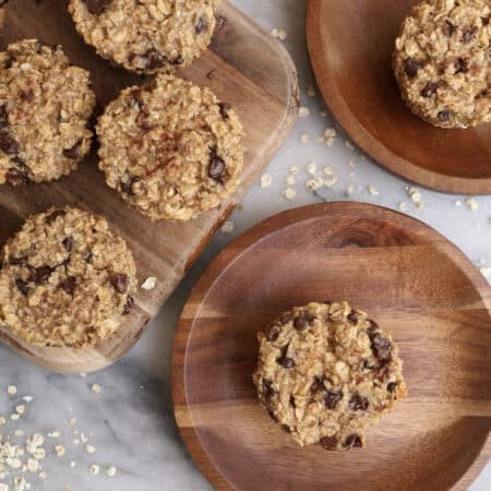 Baked oatmeal cups with peanut butter and chocolate chips on wood plates.