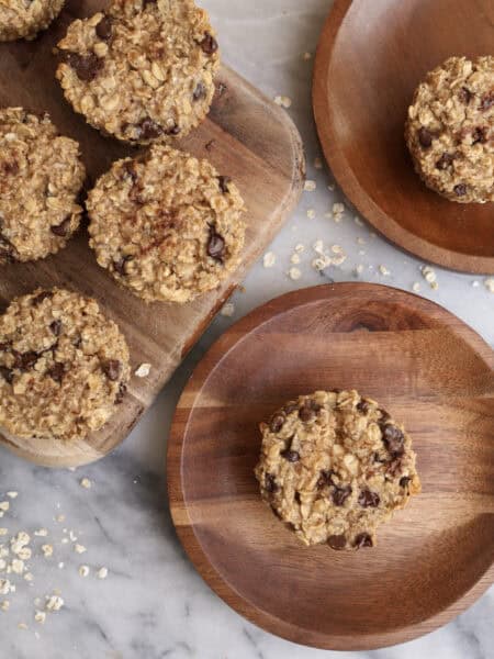 Baked oatmeal cups with peanut butter and chocolate chips on wood plates.