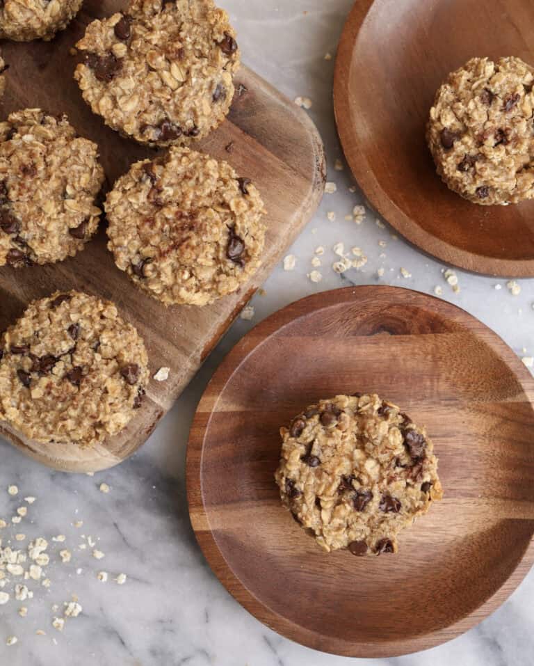 Baked oatmeal cups with peanut butter and chocolate chips on wood plates.