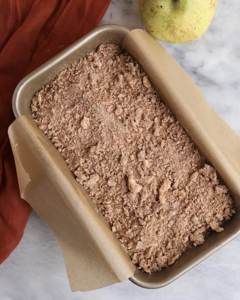 Pear loaf cake with crumble topping before going in the oven to be baked. 
