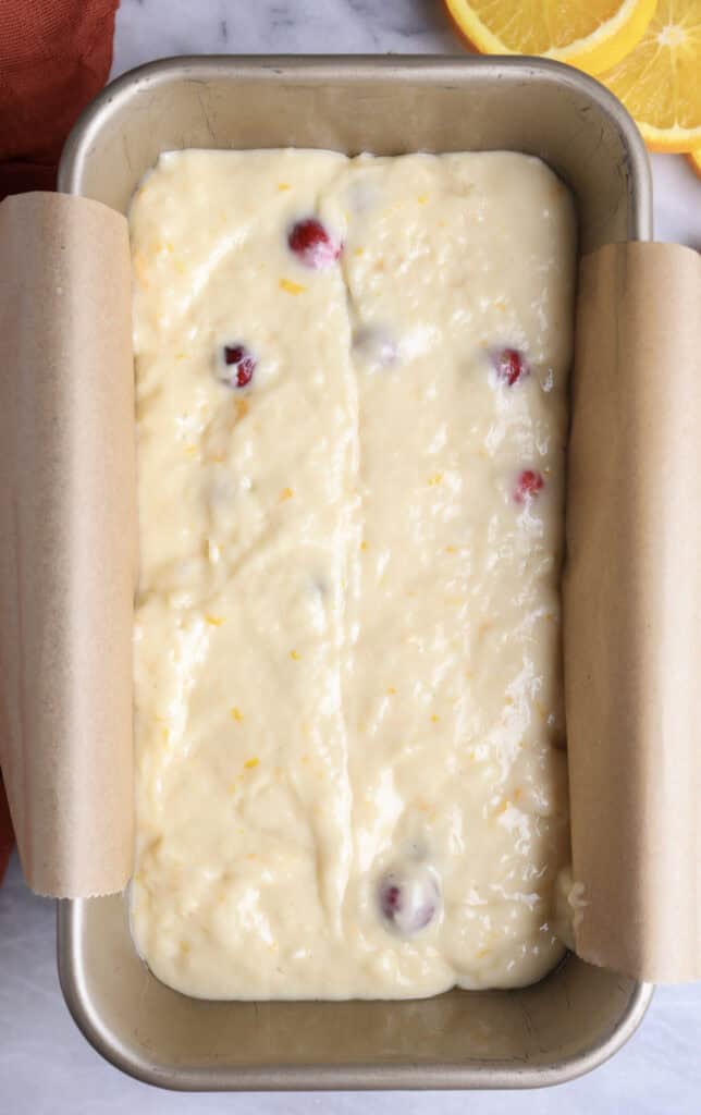 The cranberry orange batter in a loaf pan before being baked.